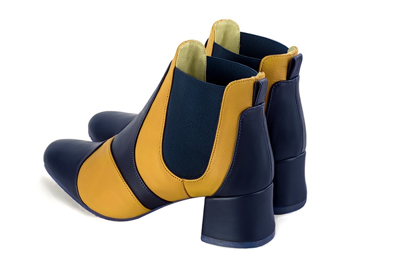 Navy blue and mustard yellow women's ankle boots, with elastics. Round toe. Low flare heels. Rear view - Florence KOOIJMAN